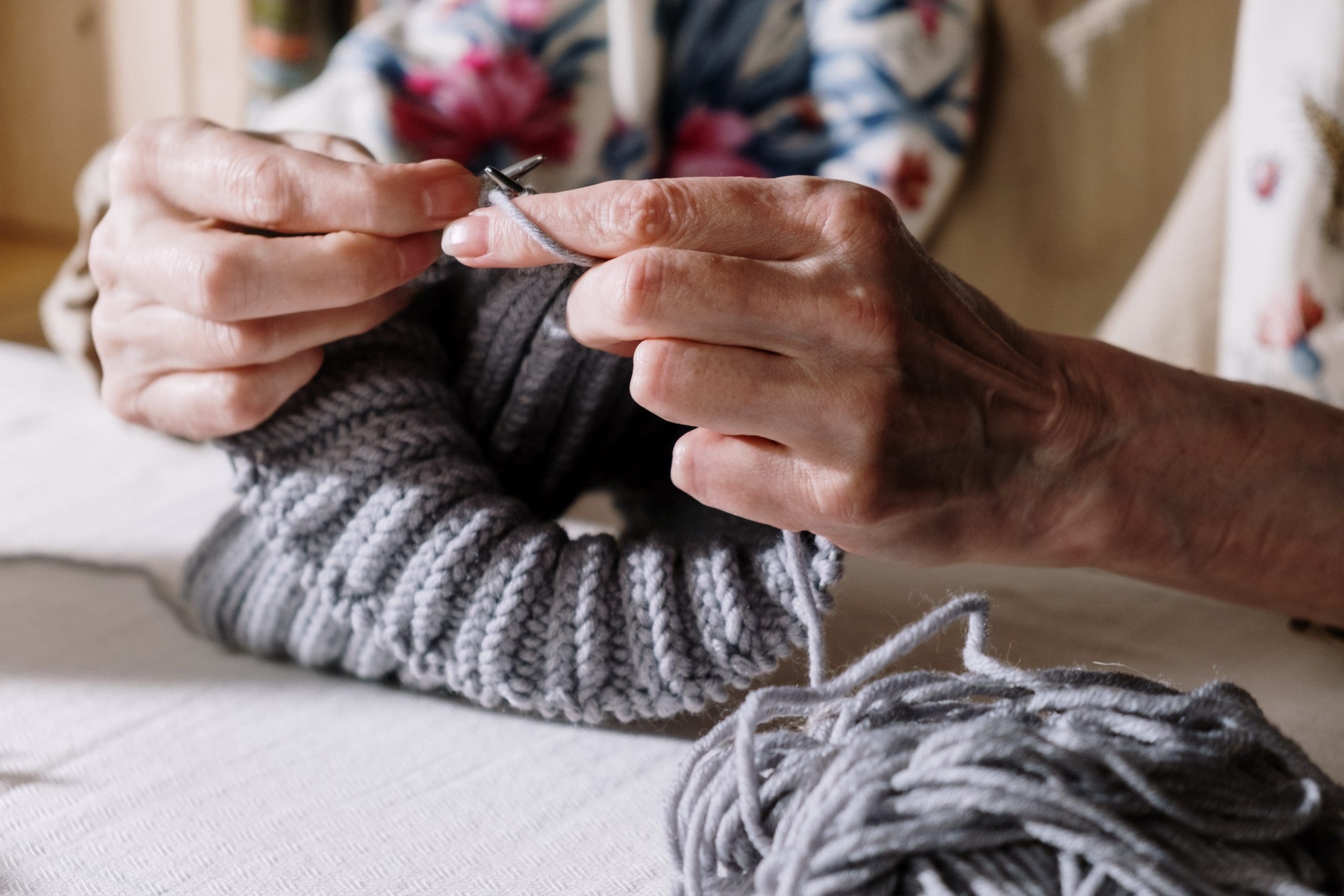 Older lady doing some knitting close up