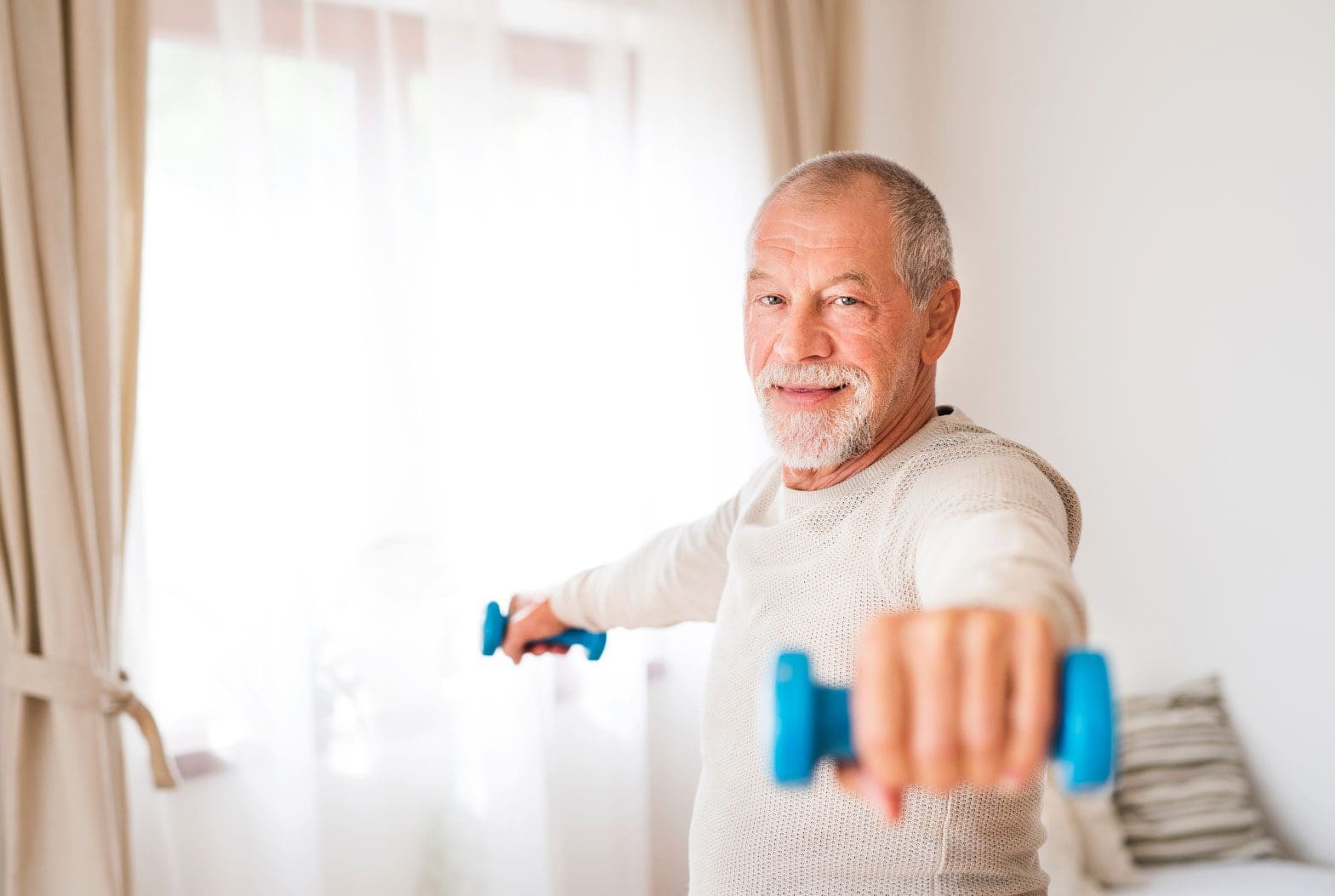 Elderly man exercising with weights