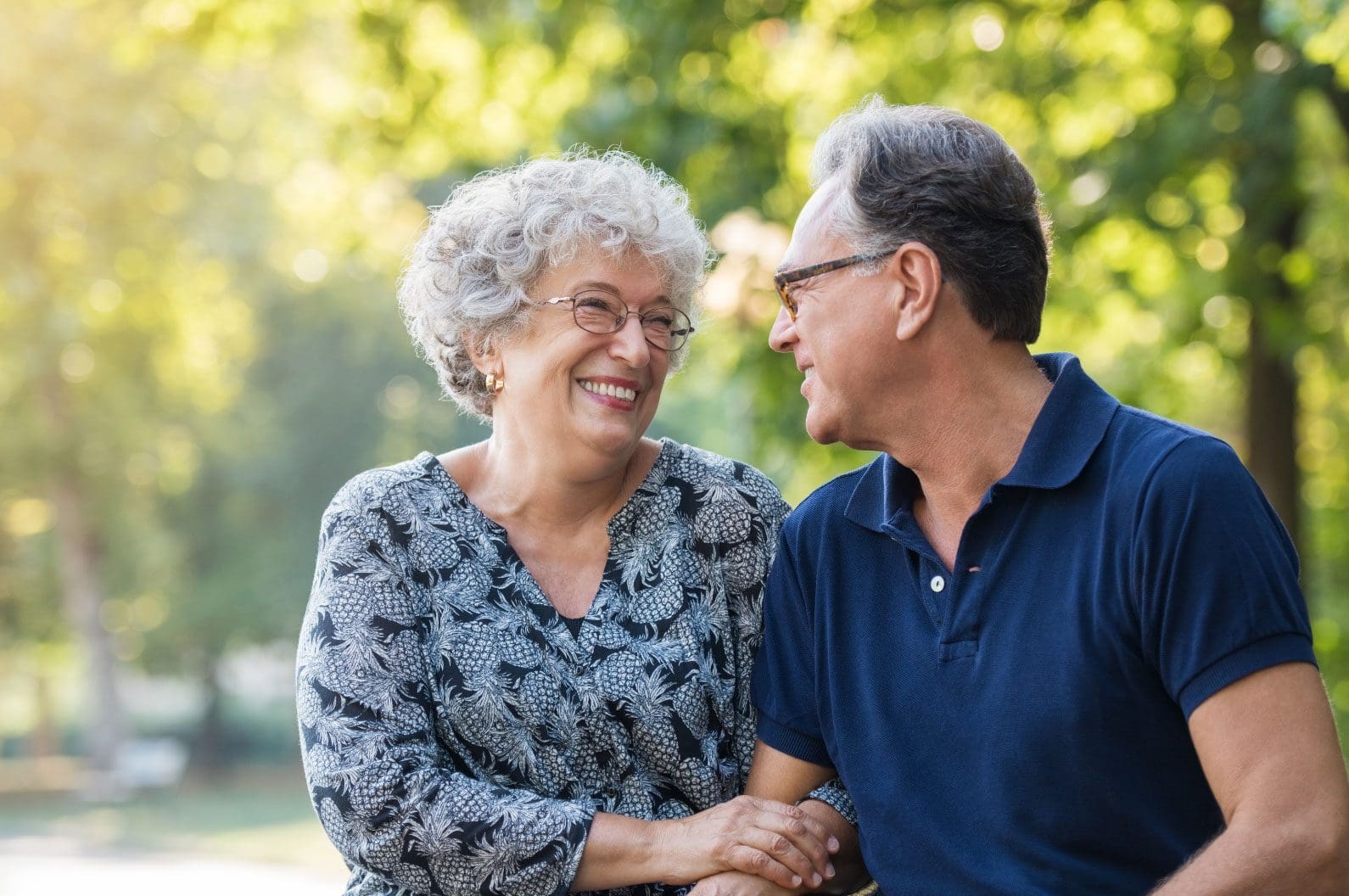 Elderly couple smiling outdoors